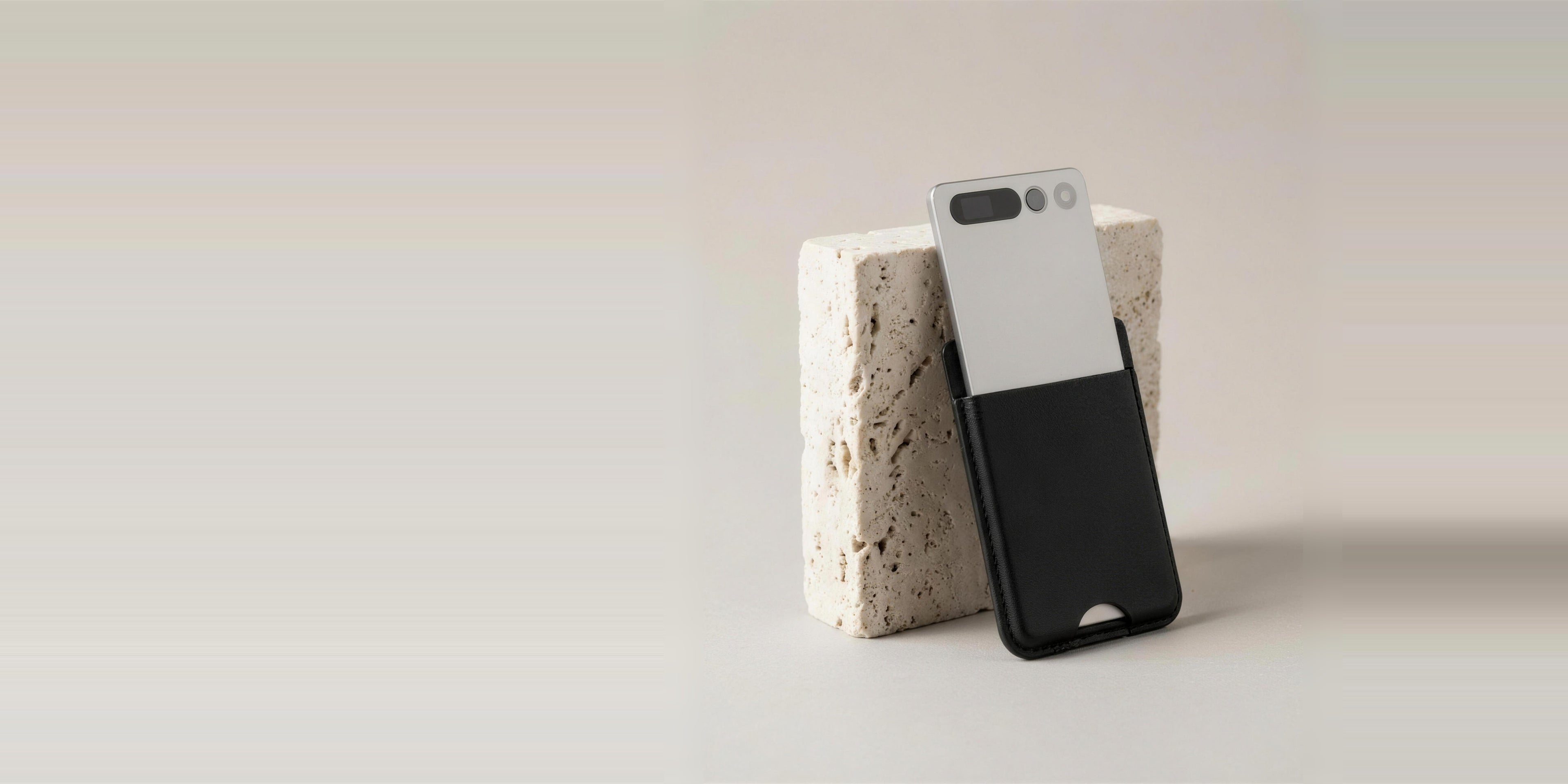notu R1 Pro leaning against travertine stone with open studio space