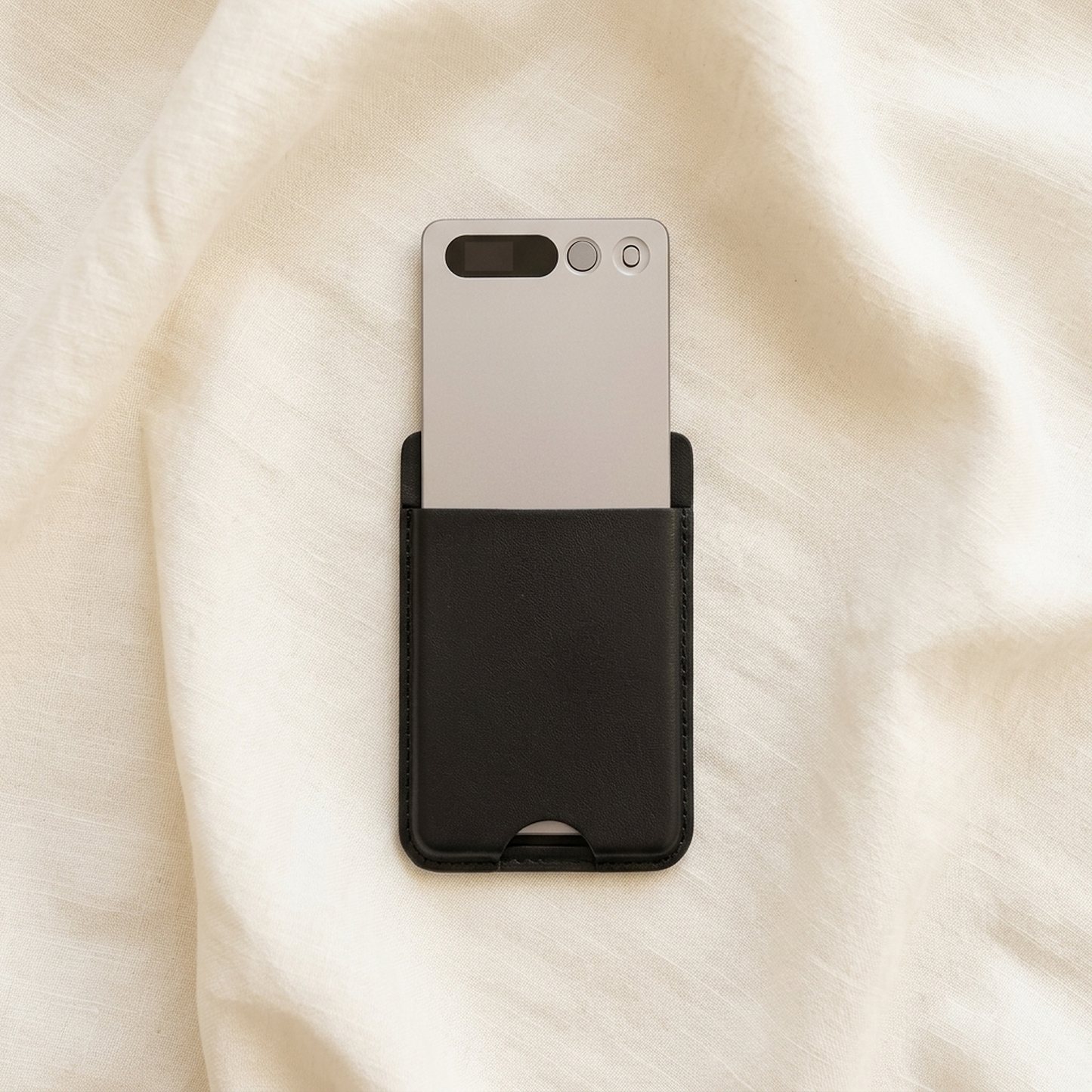 notu R1 Pro recorder card half-drawn from its leather wallet, resting on ivory linen fabric