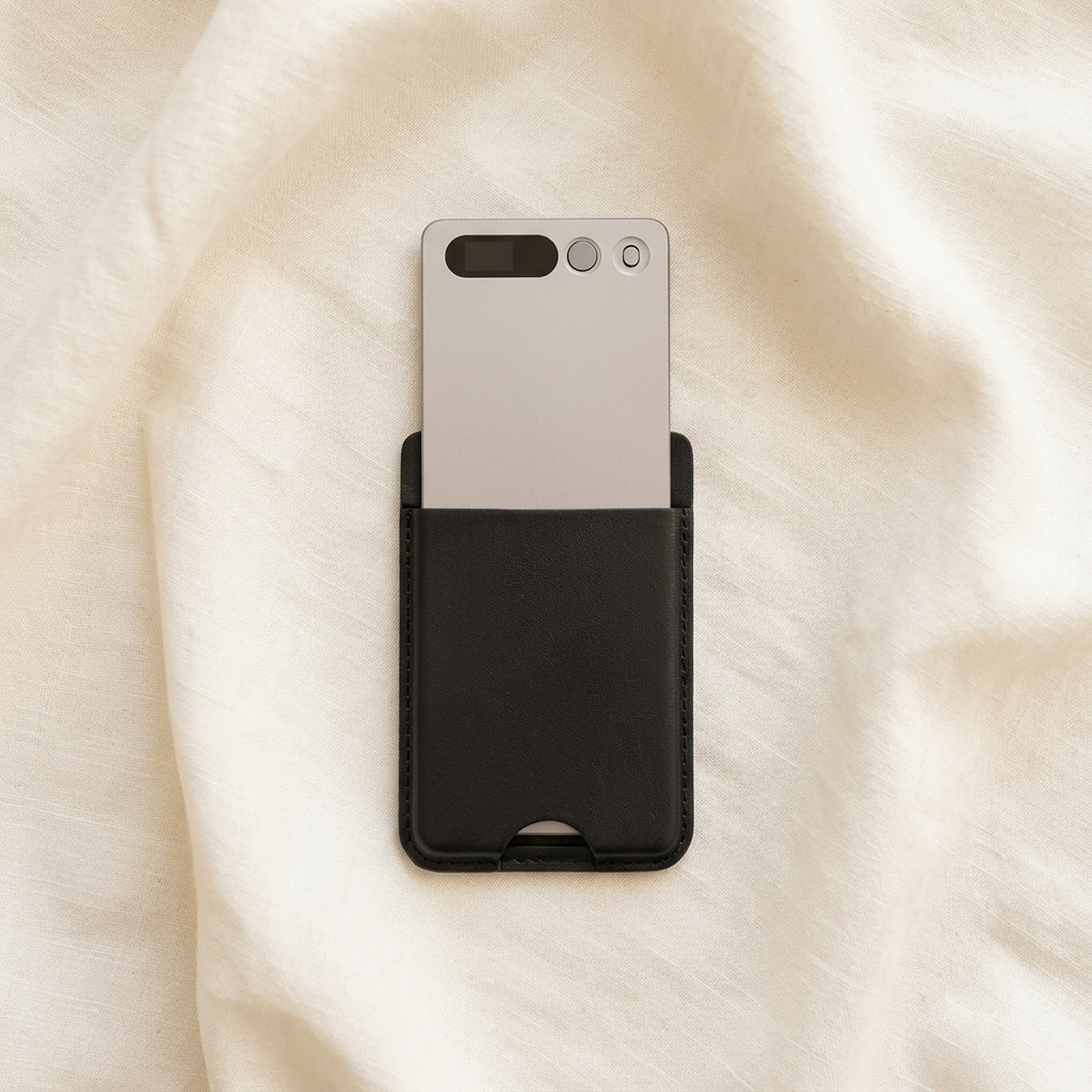 notu R1 Pro recorder card half-drawn from its leather wallet, resting on ivory linen fabric