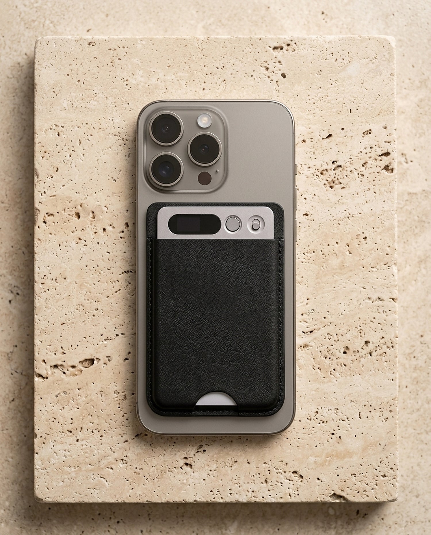notu R1 Pro attached via MagSafe to the back of an iPhone on travertine stone